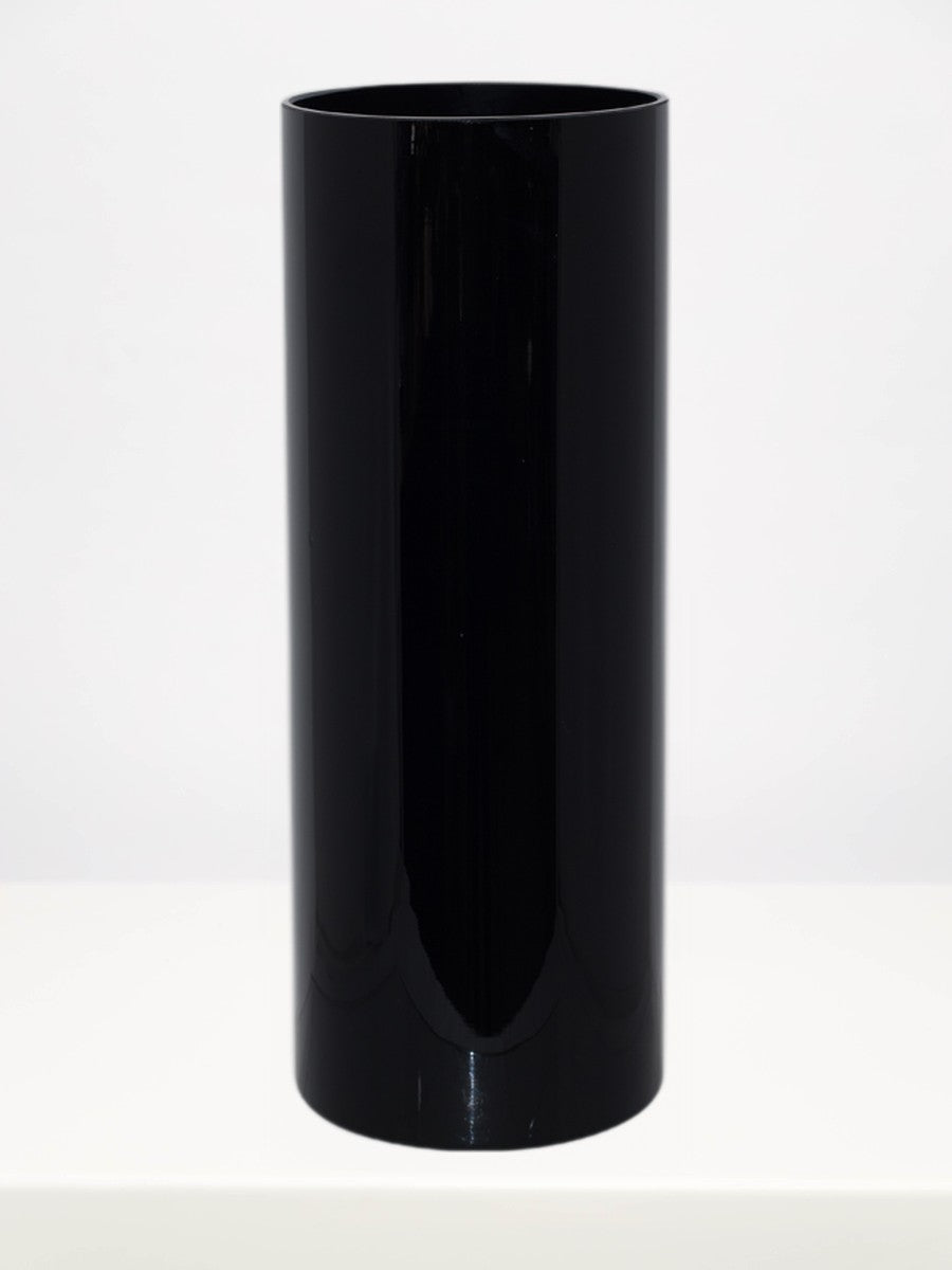Black Cylinder Vase - 40cm on a white table against a soft grey wall