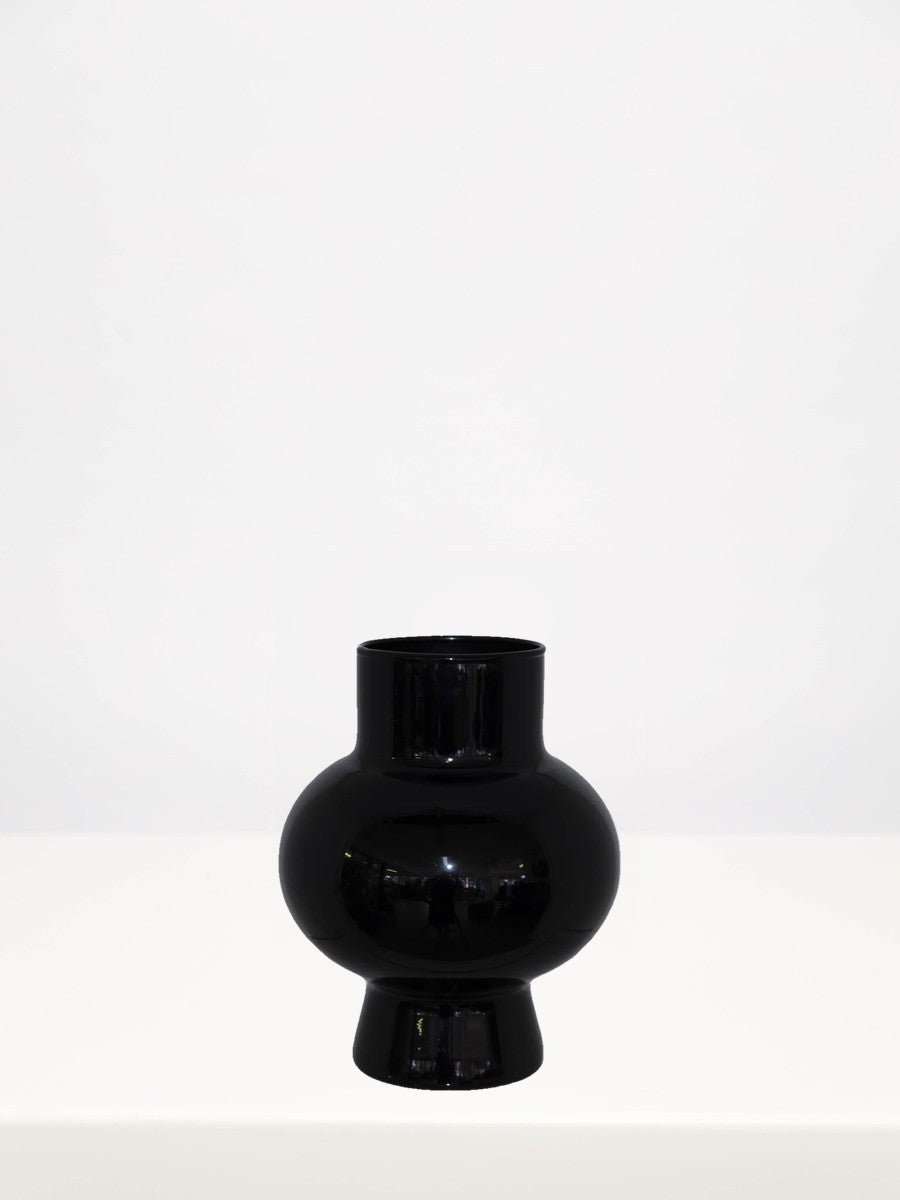 Black Saturn Vase - 18cm on a white table against a soft grey wall