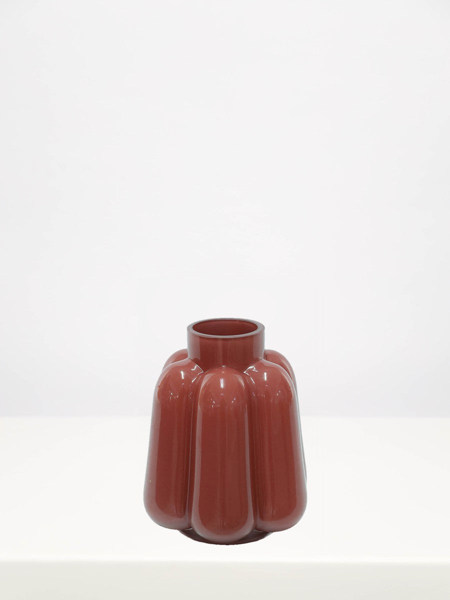 Deep Coral Vase - 18cm on a white table against a soft grey wall