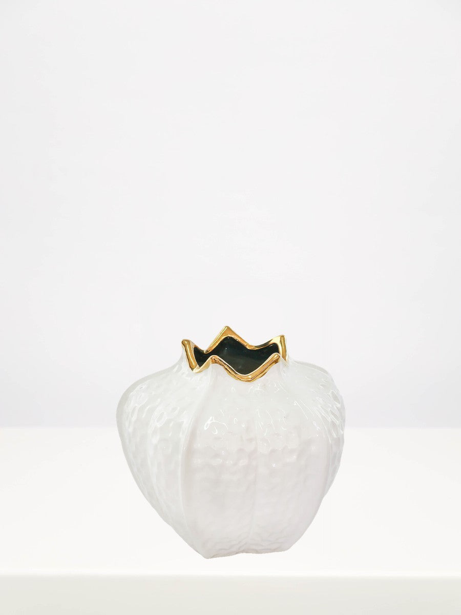 Gold & White Pomegranate Vase - 18cm on a white table against a soft grey wall