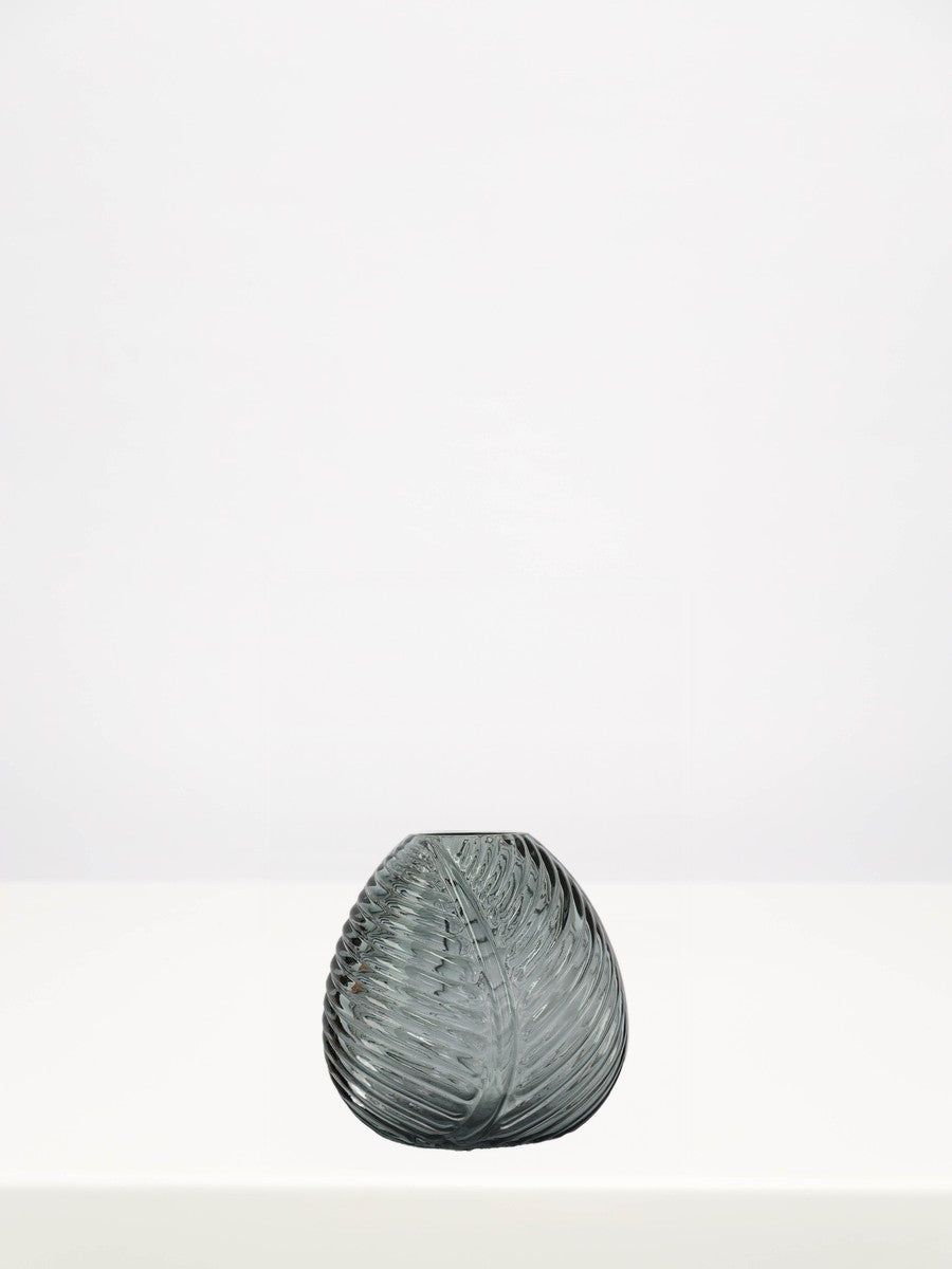 Grey Leaf Bud Vase - 12cm on a white table against a soft grey wall