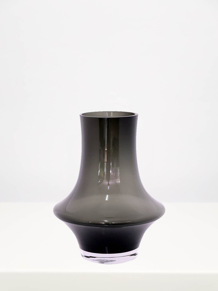 Heather Grey Optic Vase - 25cm on a white table against a soft grey wall