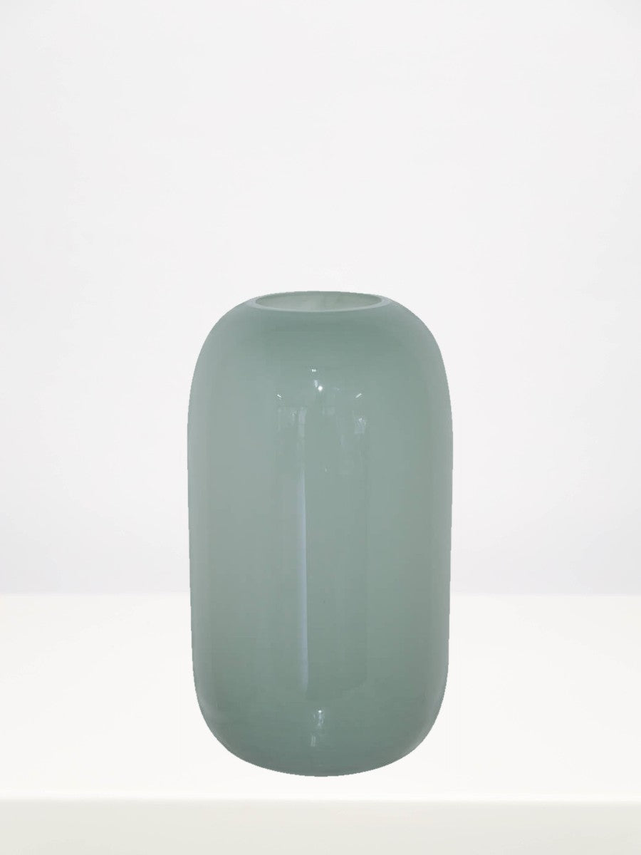 Sage Green Vase - 27cm on a white table against a soft grey wall