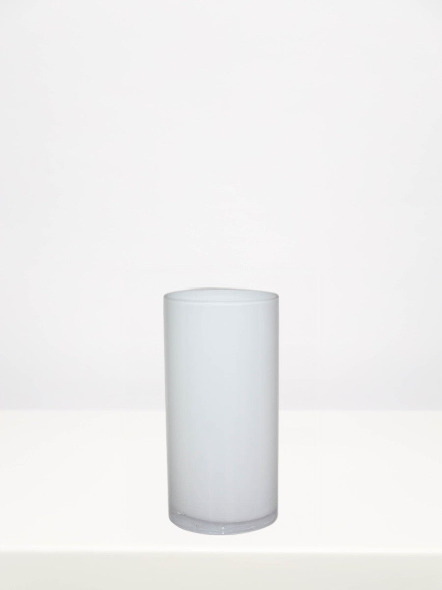 White Cylinder Vase - 20cm on a white table against a soft grey wall